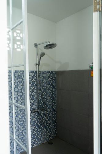 a shower with a shower head in a bathroom at SIP Garden Villa in Cibeuteung Udik