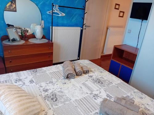 a bedroom with a bed with two towels on it at Villa Elma in Gouves