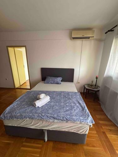 a bedroom with a bed with towels on it at Peace in the heart of downtown in Pančevo