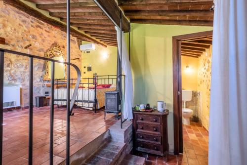 a room with a bedroom and a bed in it at Agriturismo Podere Marroneto in Monticiano