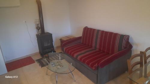 a living room with a couch and a table at Rahati in Pramanta - Ραχάτι στου Τσακτσίρα in Pramanta