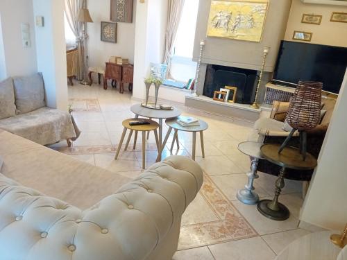 a living room with a couch and a fireplace at Villa Elma in Gouves