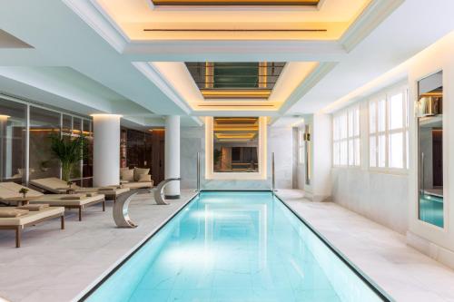 a pool in the lobby of a hotel at Casa de las Artes, member of Meliá Collection in Madrid