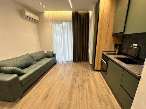 a living room with a couch and a kitchen at Seaside Escape Apartment 6 in Golem