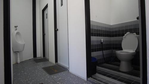 a bathroom with a toilet and a urinal at Scuba Square Hostel in Koh Tao