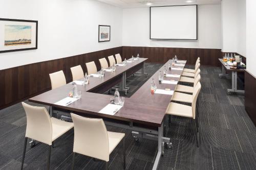 a conference room with a long table and chairs at Melia Barajas in Madrid
