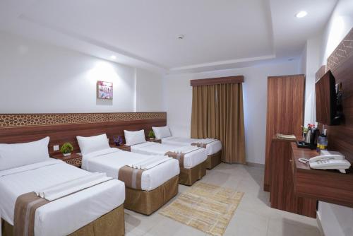 a hotel room with two beds and a television at فندق سيف بلص 1 من اورفانا in Makkah