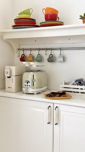 a kitchen counter with a toaster on a shelf at Palazzo Ammicc in Bernalda