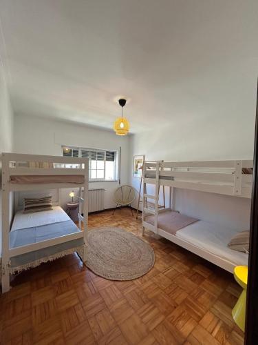 two bunk beds in a room with a wooden floor at Casa Na Vila in Vila Pouca de Aguiar