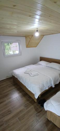 a bedroom with two beds and a window at Bujtina Sherifaj in Valbonë