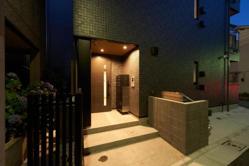 a house with a staircase leading to the front door at Yamanote walk for 8mins, New APT on Local shopping street in Tokyo