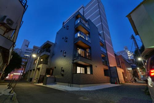 a building on a city street at night at Yamanote walk for 8mins, New APT on Local shopping street in Tokyo