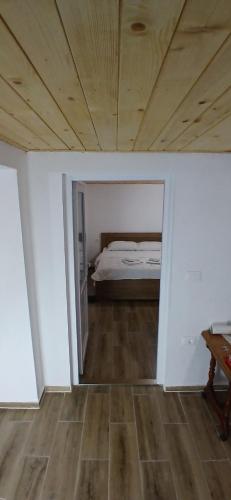 a bedroom with a bed and a wooden floor at Bujtina Sherifaj in Valbonë