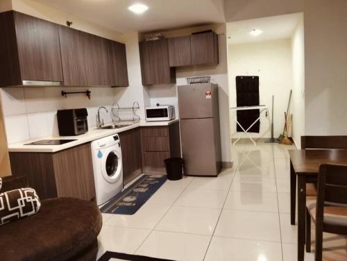 a kitchen with a refrigerator and a dishwasher in it at Hyve Soho Suite - Netflix in Cyberjaya