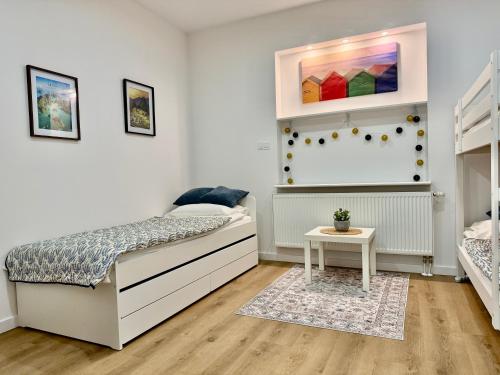 a bedroom with two beds and a table at Nowoczesny Dom z Ogrodem w Warszawie 'NOWY OBIEKT' in Warsaw