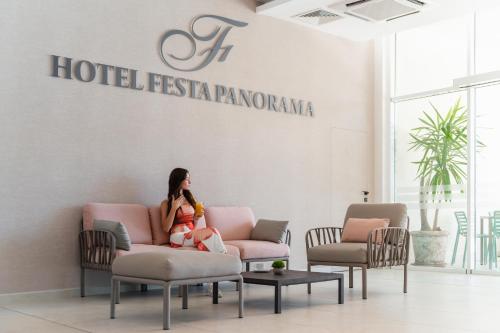 a woman sitting on a chair with a baby at Festa Panorama Hotel in Nesebar