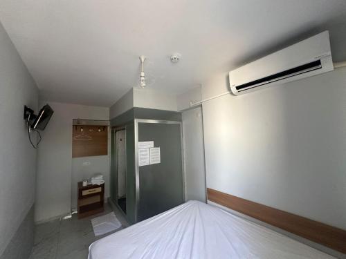 a bedroom with a white bed and a fan at Nr1 Pansiyon in Canakkale