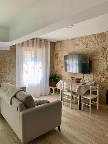 a living room with a couch and a table at Brisa Azul in Moaña