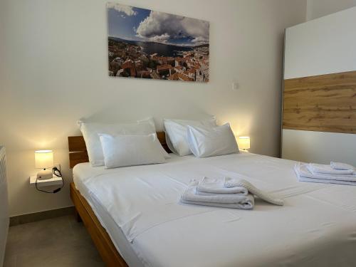 a white bed with towels on top of it at Villa Panorama in Senj
