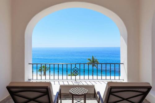 a room with a balcony with a view of the ocean at Hacienda del Mar Los Cabos, an Autograph Collection All-Inclusive Resort in Cabo San Lucas