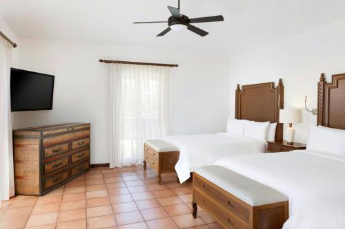 a bedroom with two beds and a ceiling fan at Hacienda del Mar Los Cabos, an Autograph Collection All-Inclusive Resort in Cabo San Lucas