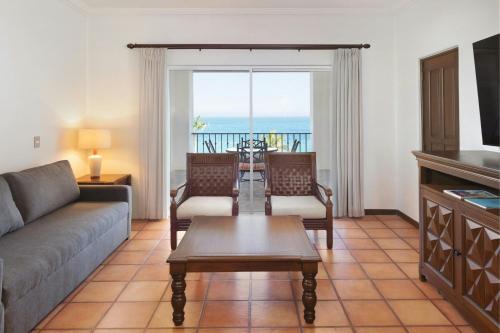 a living room with a couch and a table at Hacienda del Mar Los Cabos, an Autograph Collection All-Inclusive Resort in Cabo San Lucas