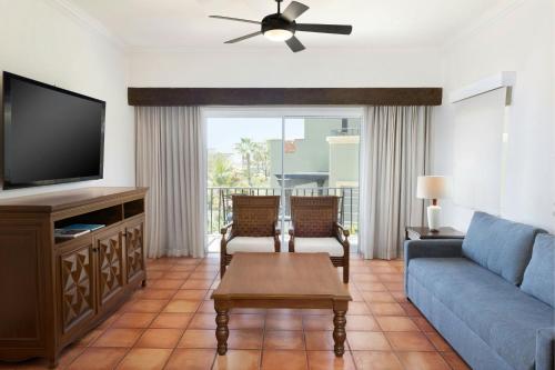 a living room with a couch and a tv at Hacienda del Mar Los Cabos, an Autograph Collection All-Inclusive Resort in Cabo San Lucas