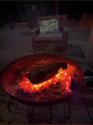 a fire pit with a fish cooking in it at Sandalwood Downs Fabulous Farm Stay TOODYAY in Toodyay