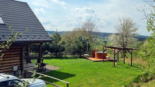 a backyard with a gazebo and a picnic table at Domki Na Wzgórzu in Nowica