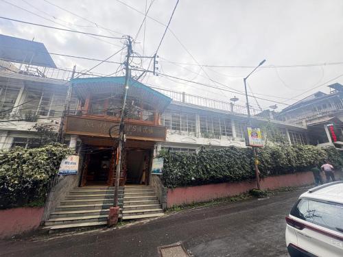 a building with stairs in front of a building at Darjeeling Mall is 700 m From Apsara Darjeeling Pure veg in Darjeeling