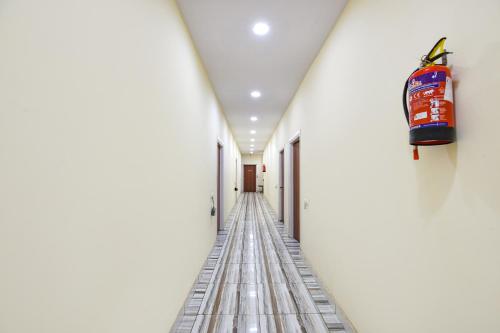 a hallway of a building with a fire extinguisher on the wall at FabExpress High View in Faridabad