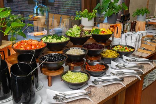 a buffet with bowls of different types of vegetables at OREA Resort Panorama Moravský kras in Blansko