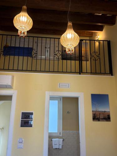 two chandeliers are hanging in a bathroom with a toilet at Palazzo Florio Boutique Residence in Vasto
