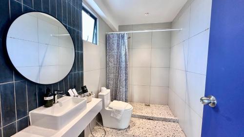 a bathroom with a sink and a mirror and a toilet at Ukiyo Hotel by manatidur in Petaling Jaya