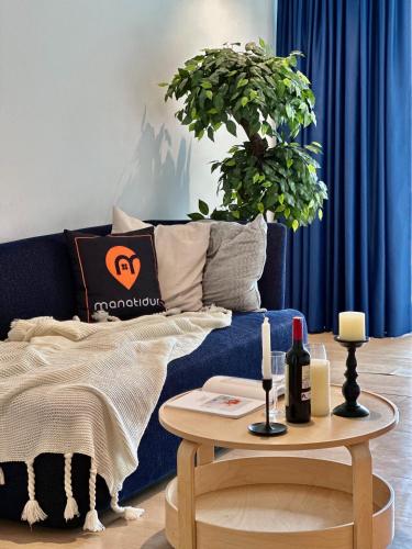a living room with a blue couch and a table at Ukiyo Hotel by manatidur in Petaling Jaya
