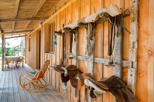 a room with wooden walls with cowboy shoes on the wall at L'Escale du Dernier Pin in Escalans
