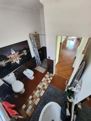a bathroom with two toilets and a tv on the wall at Villa BleuBlanca Tangier in Tangier