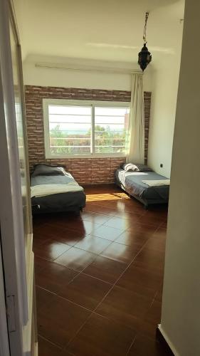 a room with two beds and a brick wall at Villa BleuBlanca Tangier in Tangier