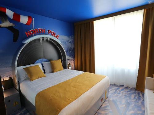 a bedroom with a bed with a north pole sign on the wall at Gardaland Adventure Hotel in Castelnuovo del Garda