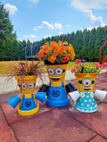three vases with flowers in them on a table at Studio apartma Žirovnik in Cerklje na Gorenjskem