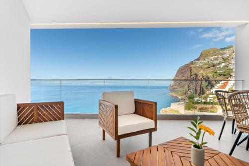 a living room with a view of the ocean at Atlantis Apartment in Câmara de Lobos