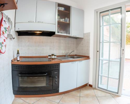 a kitchen with a sink and a stove at Aurelia Blu in Santo Stefano al Mare