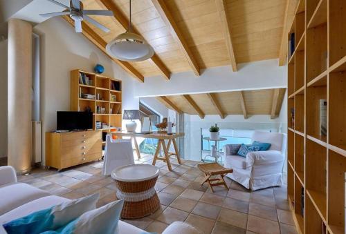 a living room with a couch and a table at Villa Vollard Panoramic Seaview & Private Pool in Rodia