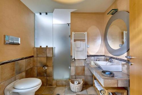 a bathroom with a toilet and a sink and a mirror at Villa Vollard Panoramic Seaview & Private Pool in Rodia