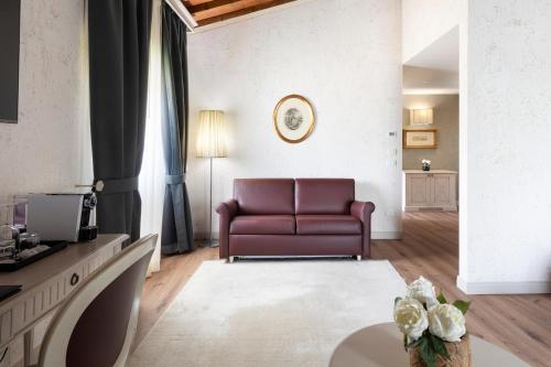 a living room with a couch and a table at LHP Hotel Certaldo in Certaldo
