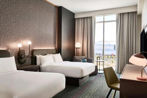 a hotel room with two beds and a window at Renaissance Phoenix Glendale Hotel & Conference Center in Glendale