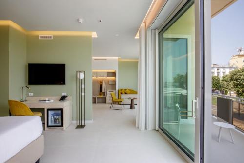 a hotel room with a bed and a sliding glass door at Ambasciatori Suite Hotel in Sottomarina