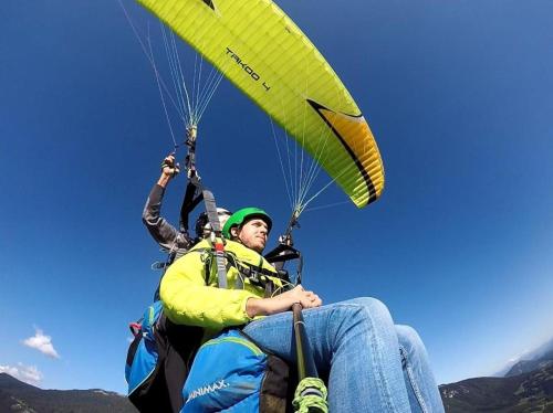 a man riding a parachute in the sky at Le Essaouira - Gare Bellegarde - Direct Genève in Bellegarde-sur-Valserine