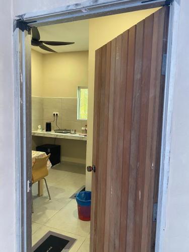 an open door to a kitchen with a room at Simply Studio Hotel Parit Raja in Batu Pahat