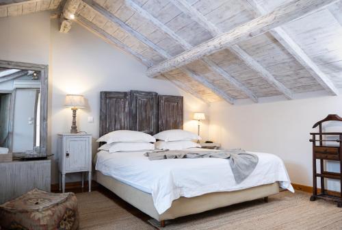 a bedroom with a large bed with white sheets and pillows at Amymone and Adiandi in Nafplio